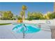 Inviting backyard with a sparkling pool, spa, and lush landscaping, perfect for relaxation and entertaining at 2107 Fountain Springs Dr, Henderson, NV 89074