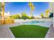 Inviting backyard with a refreshing pool, spa, and lush green turf area, ideal for outdoor enjoyment at 2107 Fountain Springs Dr, Henderson, NV 89074