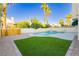 Inviting backyard with a refreshing pool, spa, and lush green turf area, ideal for outdoor enjoyment at 2107 Fountain Springs Dr, Henderson, NV 89074