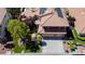 Two-story home features a tile roof, solar panels, mature trees and shrubbery, and a three-car garage at 2208 Fiero Dr, Las Vegas, NV 89134
