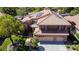 Aerial view of a two-story home showcases a tiled roof, solar panels, and a beautifully landscaped yard at 2208 Fiero Dr, Las Vegas, NV 89134