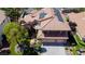 Aerial view of a house with solar panels, tile roof, well-maintained landscaping, and a three-car garage at 2208 Fiero Dr, Las Vegas, NV 89134
