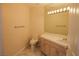 Well-lit bathroom with granite counters, cabinets, toilet, towel rack, and vanity lighting at 2208 Fiero Dr, Las Vegas, NV 89134
