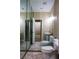 Bright bathroom featuring a toilet, a pedestal sink, and large mirrors at 2208 Fiero Dr, Las Vegas, NV 89134