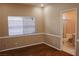 Comfortable bedroom featuring wood floors, a large window, and doorway to the bathroom at 2208 Fiero Dr, Las Vegas, NV 89134