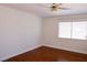 Bedroom with hardwood floors, baseboard trim, and window with horizontal blinds at 2208 Fiero Dr, Las Vegas, NV 89134
