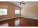Large, bright bedroom with hardwood floors, a ceiling fan, and large windows at 2208 Fiero Dr, Las Vegas, NV 89134