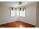 Well-lit bedroom with hardwood floors, ceiling fan, and shuttered windows with fabric valances at 2208 Fiero Dr, Las Vegas, NV 89134