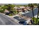 Gated community entrance featuring landscaped grounds, palm trees, and mountain views at 2208 Fiero Dr, Las Vegas, NV 89134