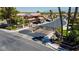 Gated community entrance with lush landscaping, security gates, and surrounding houses at 2208 Fiero Dr, Las Vegas, NV 89134