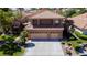 Two-story home featuring a tile roof, three-car garage, and meticulously landscaped front yard at 2208 Fiero Dr, Las Vegas, NV 89134
