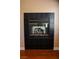 Tile-surround fireplace featuring a black tile and brass trim in a living space at 2208 Fiero Dr, Las Vegas, NV 89134