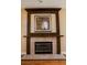 Elegant fireplace featuring a decorative wooden mantel and tile hearth at 2208 Fiero Dr, Las Vegas, NV 89134