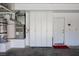 Clean garage interior featuring white storage cabinets and a water heater at 2208 Fiero Dr, Las Vegas, NV 89134