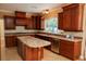Well-equipped kitchen with custom cabinetry, tile backsplash, and granite countertop island at 2208 Fiero Dr, Las Vegas, NV 89134