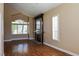 Inviting living room with a fireplace, large window and wood floors at 2208 Fiero Dr, Las Vegas, NV 89134