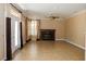 Spacious living room with tiled flooring, fireplace, and double doors leading outside at 2208 Fiero Dr, Las Vegas, NV 89134