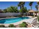 Inviting backyard swimming pool with lounge chairs and an outdoor gazebo at 2208 Fiero Dr, Las Vegas, NV 89134