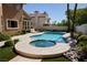 Backyard pool and spa with lounge chairs surrounded by lush landscaping on a sunny day at 2208 Fiero Dr, Las Vegas, NV 89134