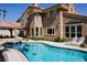 Stunning backyard pool and covered patio with a beautiful home exterior at 2208 Fiero Dr, Las Vegas, NV 89134