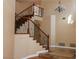 Staircase with wrought iron railing, tile steps and a decorative light fixture at 2208 Fiero Dr, Las Vegas, NV 89134