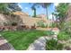 Grassy backyard with brick borders and landscape at 2417 Chestnut Hill St, Las Vegas, NV 89134