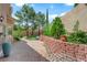 Backyard featuring lush greenery and charming brick pathway at 2417 Chestnut Hill St, Las Vegas, NV 89134