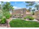 View of the home's backyard featuring a manicured lawn and hardscaped patio at 2417 Chestnut Hill St, Las Vegas, NV 89134