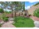Grassy backyard with brick borders and large trees at 2417 Chestnut Hill St, Las Vegas, NV 89134