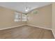 Neutral bedroom with wood-look floors, vaulted ceiling and bright windows at 2417 Chestnut Hill St, Las Vegas, NV 89134