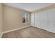 Neutral bedroom with light-tone floors and closet doors with white trim and window at 2417 Chestnut Hill St, Las Vegas, NV 89134