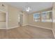 Large bedroom features wood-look floors, ceiling fan, bright windows, and en-suite bathroom at 2417 Chestnut Hill St, Las Vegas, NV 89134