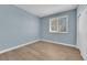 Bedroom painted in a light blue with wood floors, white trim and closet doors at 2417 Chestnut Hill St, Las Vegas, NV 89134