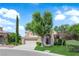 Attractive two-story home with an arched doorway, well-kept lawn, and a spacious three car garage at 2417 Chestnut Hill St, Las Vegas, NV 89134