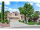Charming two-story home featuring a well-manicured lawn, and a spacious three car garage at 2417 Chestnut Hill St, Las Vegas, NV 89134