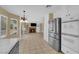 Modern kitchen leading to a living room with stainless steel appliances, and a marble countertop at 2417 Chestnut Hill St, Las Vegas, NV 89134