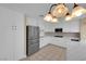 Modern kitchen with stainless steel appliances, sleek white cabinets and a marble countertop at 2417 Chestnut Hill St, Las Vegas, NV 89134