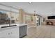 Modern kitchen leading to a living room with stainless steel appliances, and a marble countertop at 2417 Chestnut Hill St, Las Vegas, NV 89134