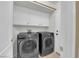Clean and functional laundry room with modern washer and dryer units, cabinets, and storage at 2417 Chestnut Hill St, Las Vegas, NV 89134