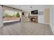 Cozy living room with a brick fireplace, built-in shelves, and a sliding glass door to the backyard at 2417 Chestnut Hill St, Las Vegas, NV 89134