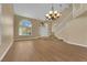 Spacious living room featuring hardwood floors, staircase, and lots of natural light from large windows at 2417 Chestnut Hill St, Las Vegas, NV 89134