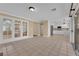 Open-concept living room with tile floors, French doors, and an open view to the kitchen at 2417 Chestnut Hill St, Las Vegas, NV 89134