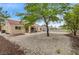 Expansive backyard featuring a covered patio, lush trees, and a serene outdoor living space at 2430 Sungold Dr, Las Vegas, NV 89134