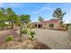 Expansive backyard showcasing gravel landscaping and the home's exterior with a covered patio at 2430 Sungold Dr, Las Vegas, NV 89134
