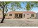 Charming backyard with covered patio, swing, seating, and ample space for outdoor relaxation and entertaining at 2430 Sungold Dr, Las Vegas, NV 89134