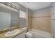 This bathroom features a shower-tub combination with decorative tiles, granite counters, and modern fixtures at 2430 Sungold Dr, Las Vegas, NV 89134