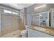 This bathroom features a tiled shower with glass doors, granite counters, and a spacious vanity at 2430 Sungold Dr, Las Vegas, NV 89134
