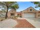 Charming single-story home with a well-manicured yard, desert landscaping, and a two-car garage at 2430 Sungold Dr, Las Vegas, NV 89134