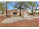 Charming single-story home featuring a terra cotta tile roof and low-maintenance desert landscaping at 2430 Sungold Dr, Las Vegas, NV 89134
