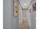 This hallway has laminate floors and decor on the walls at 2430 Sungold Dr, Las Vegas, NV 89134